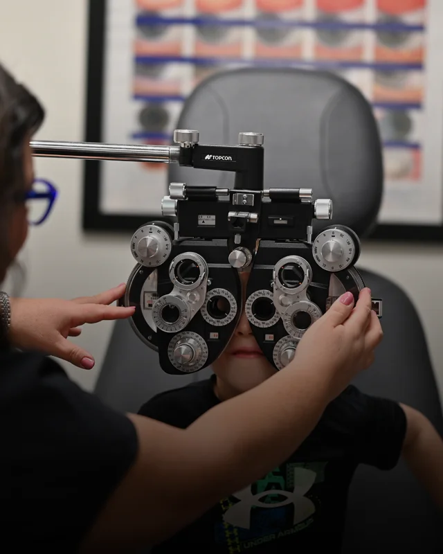 A pediatric patient sitting for an eye exam