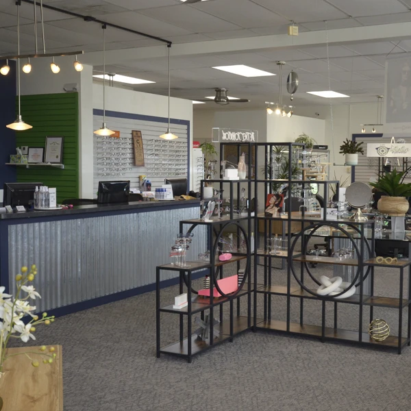Modern eyewear store interior featuring a spacious reception area and organized product displays.